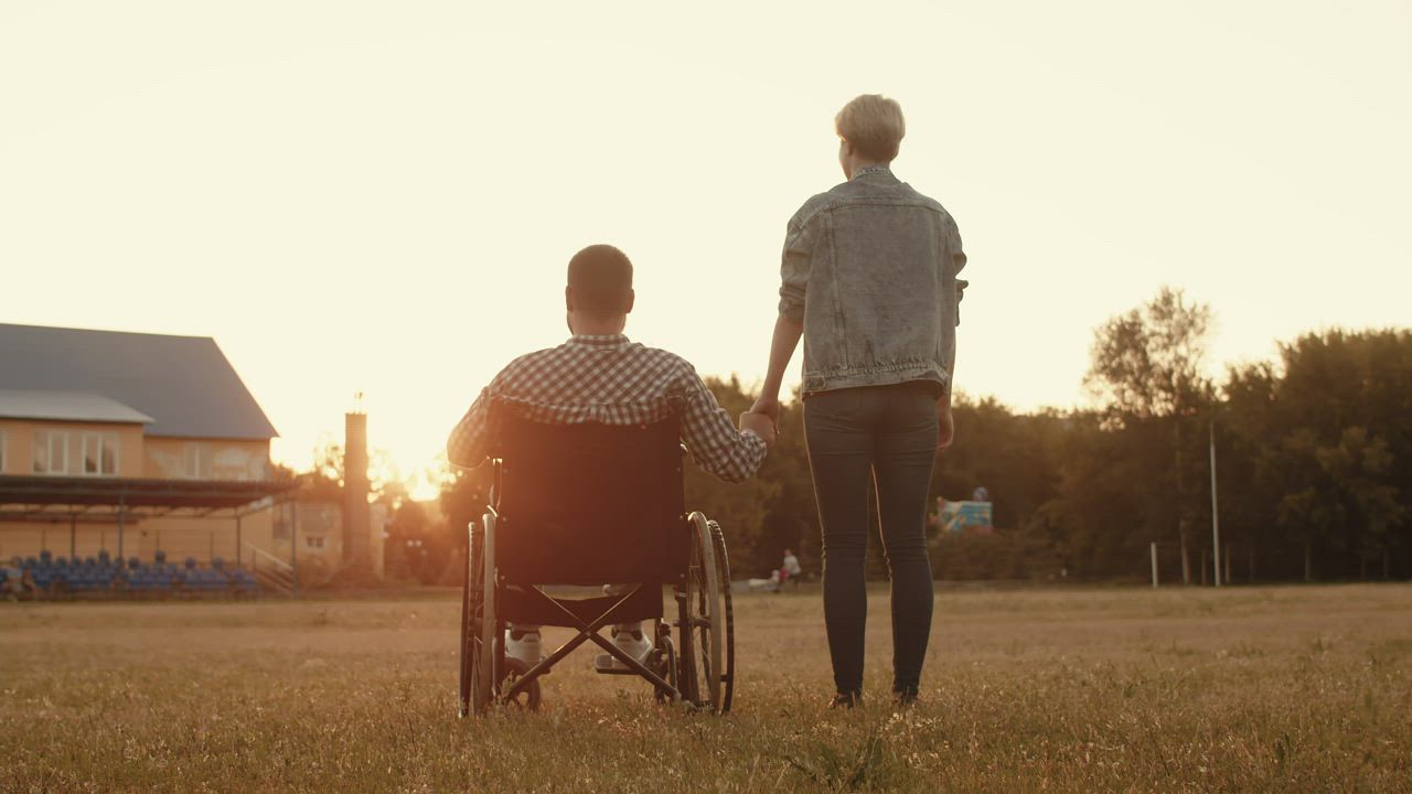 Couple holding hands at sunset